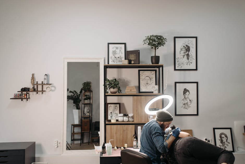 Tattoo artist working on client in a stylish and modern tattoo studio, focused and creative.