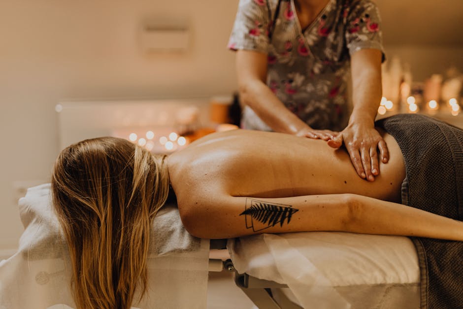 Woman receiving a therapeutic massage in a calm spa environment, promoting relaxation and wellness.